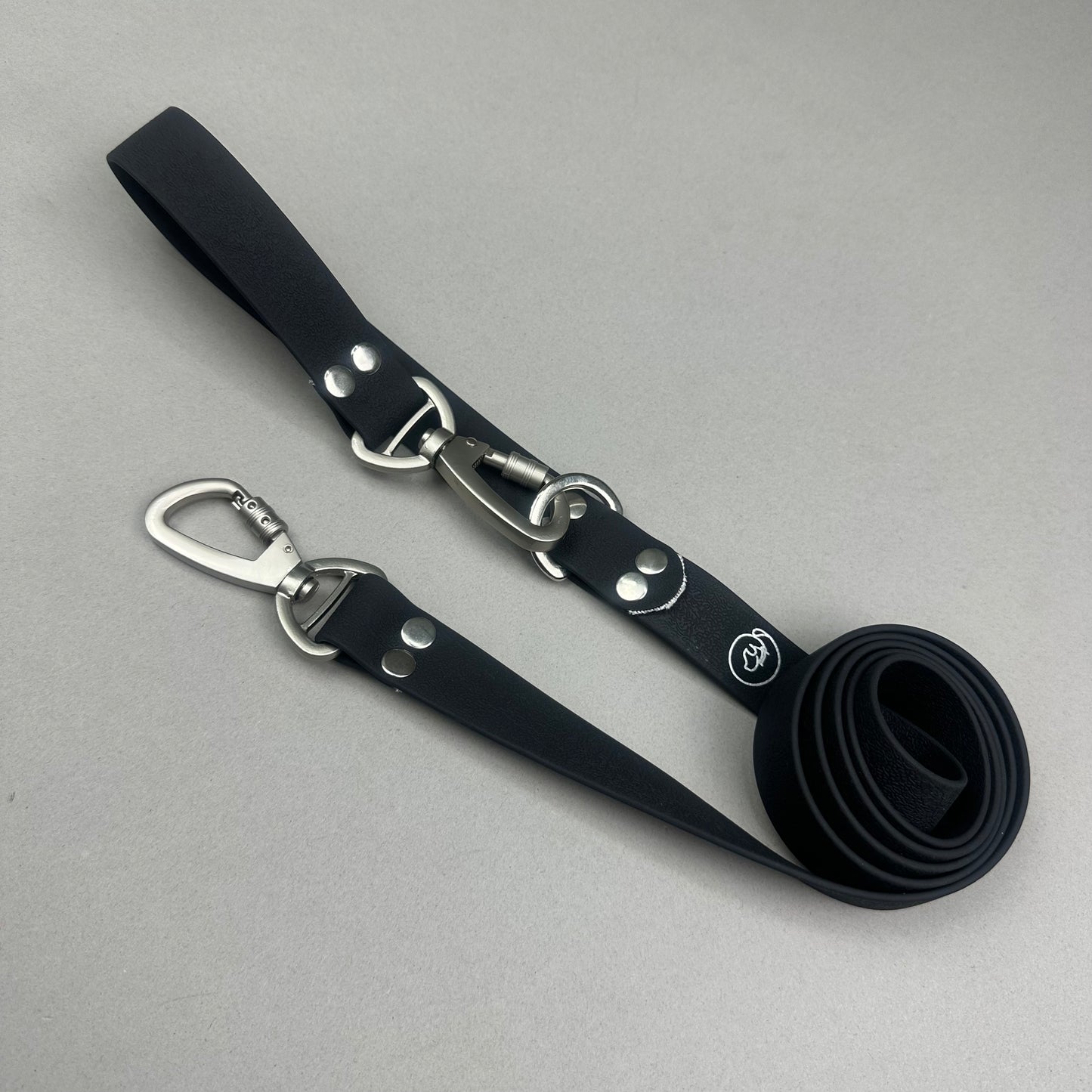 Traílla doble función Impermeable negro