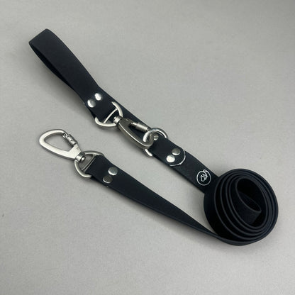 Traílla doble función Impermeable negro